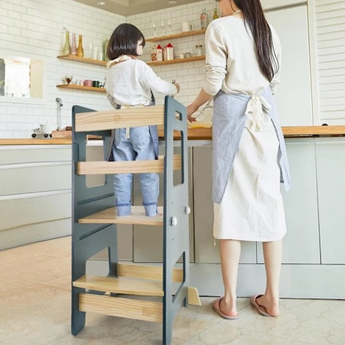 Mother and child using toddler tower to help with baking nz